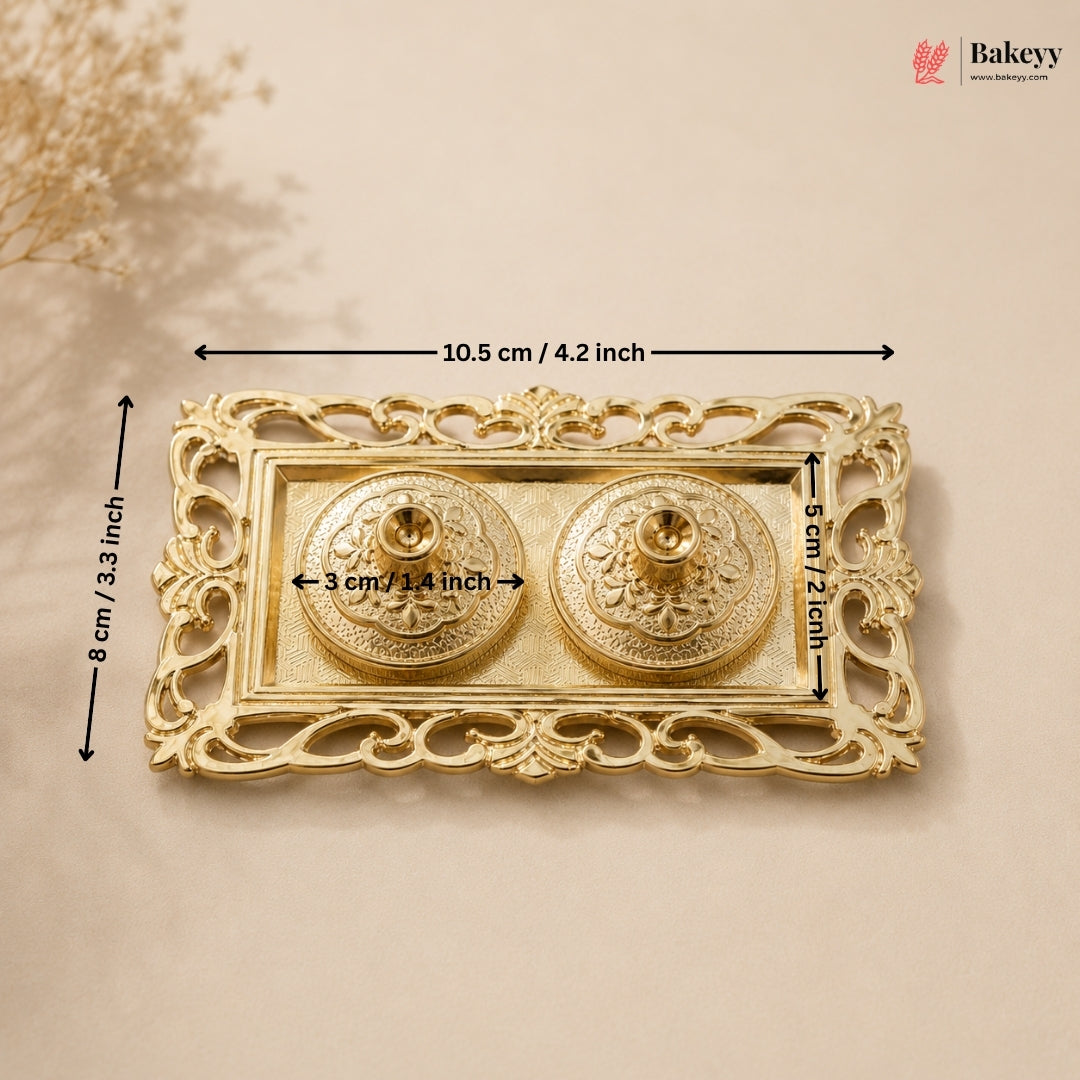 Decorative gold boxes with floral elements on a beige background