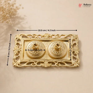 Decorative gold boxes with floral elements on a beige background