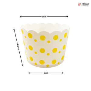 Yellow polka dot cupcake liner with dimensions on a white background