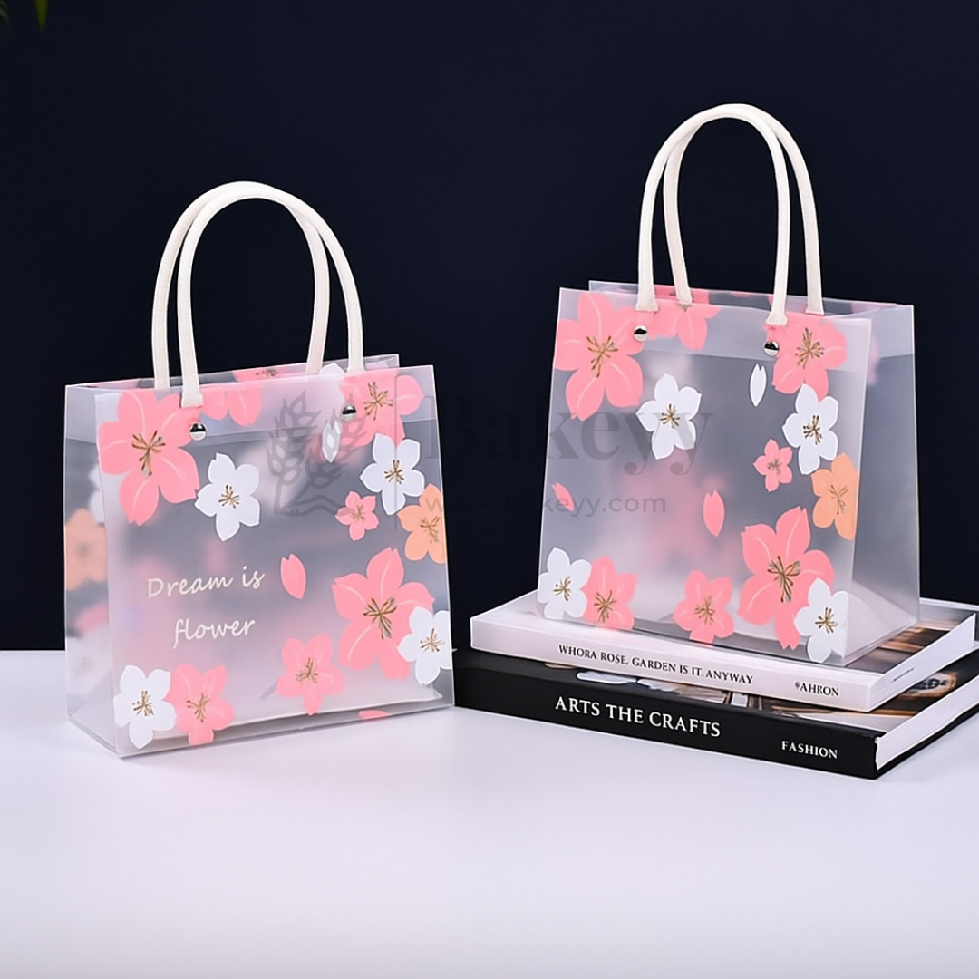 Transparent shopping bags with floral designs and white handles on a dark background.