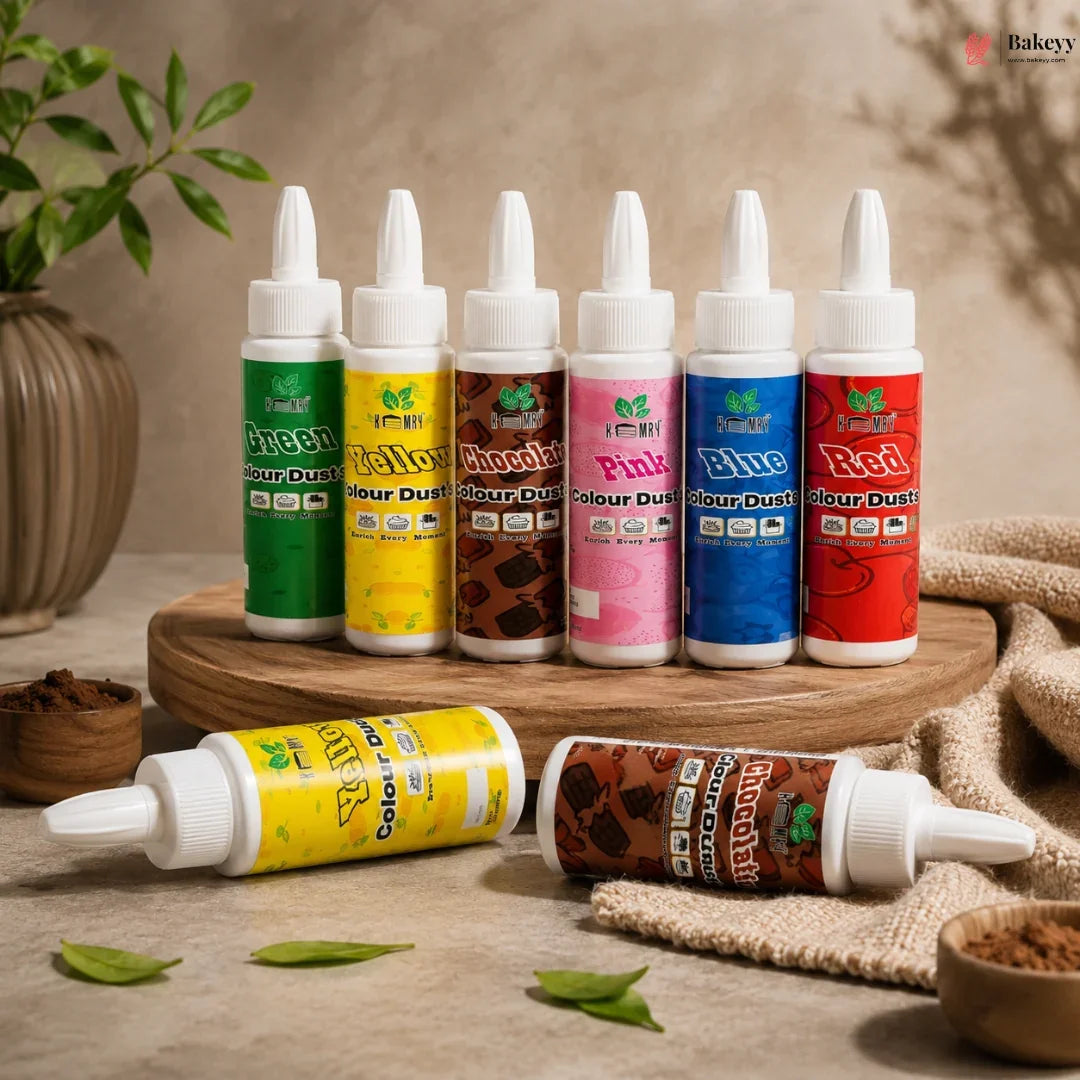 Assorted bottles of Colour Dust on a wooden surface with a neutral background