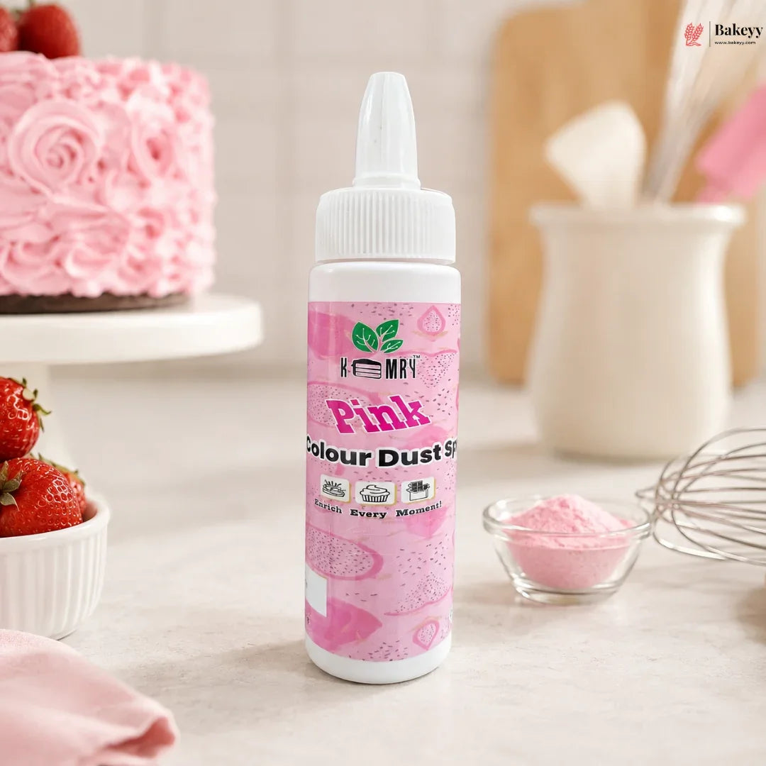 Bottle of pink food color with a cake and strawberries in the background