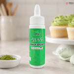 Bottle of green color dust with a background of cupcakes and a bowl of green powder.