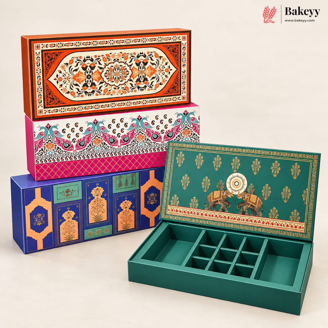 Four decorative rectangular baking boxes with intricate hand-painted traditional patterns in orange, pink, blue, and green, with one box shown open to reveal a divided interior tray compartment, set against a clean off-white background.