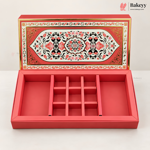 A red rectangular jewelry box with a hinged lid, shown open to reveal a nine-compartment internal organizer. The lid features an ornate, symmetrical floral pattern in red, black, and gold.