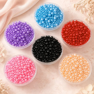 Assorted colored beads in transparent containers on a light background
