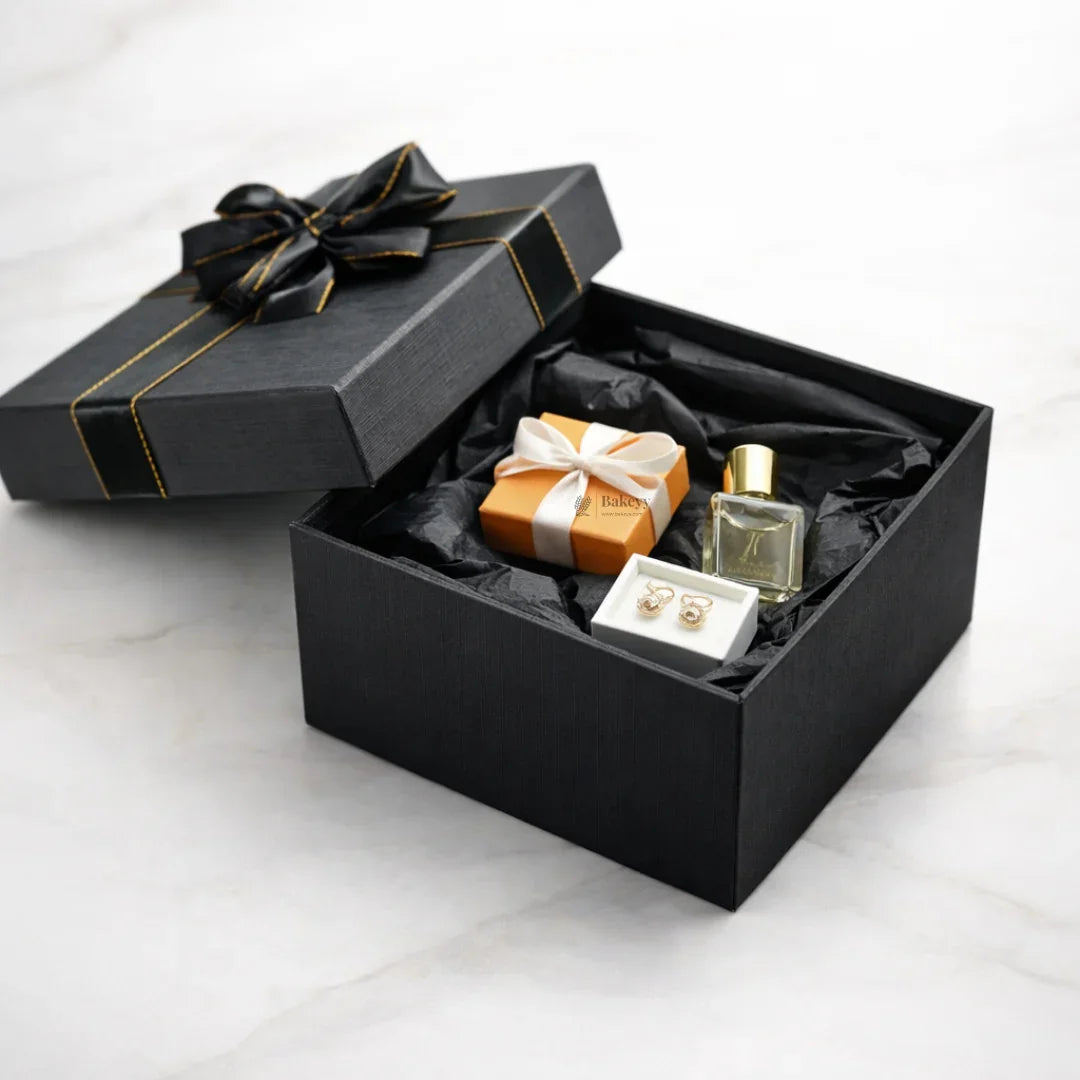 Elegant black gift box with ribbon, jewelry, small perfume, and orange gift box from Bakeyy.com