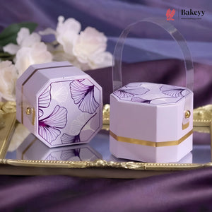 Decorative purple and gold boxes with floral patterns on a reflective surface.