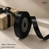 A roll of black satin ribbon with a length unspooled, shown beside a kraft paper gift box tied with a black ribbon. Text at the bottom reads 'Width : 1/2 Inch / 1.