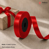 A roll of bright red satin ribbon with a black center core, shown unspooled on a beige surface next to a brown gift box tied with the ribbon. Text at the bottom reads 'Width : 1/2 Inch / 1.