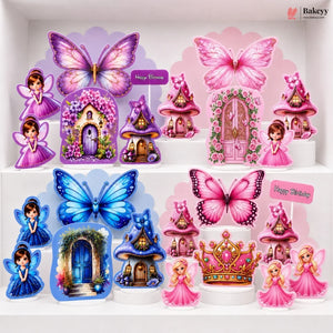 A collection of colorful fairy-themed party decorations displayed on white shelves, including pink and blue butterflies, fairy figures, miniature houses, and a crown, with 'Happy Birthday' signs.