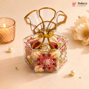 Decorative gift box with gold ribbon on a beige background, featuring Bakeyy branding.