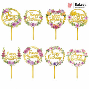 Set of 'Happy Birthday' cake toppers with floral designs on sticks, branded 'Bakeyy'.