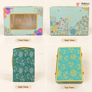 A four-panel product display showing a decorative bakery gift box from multiple angles: Front View, Back View, Side View, and Top View. The box features a light aqua background with colorful floral illustrations, gold trim, and a clear window on the front.