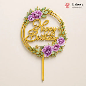 Decorative 'Happy Birthday' cake topper with purple flowers on a beige background, featuring the brand 'Bakeyy'.