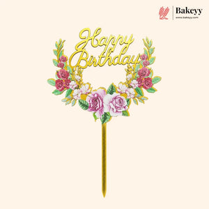 Decorative 'Happy Birthday' cake topper with floral elements on a beige background, featuring the brand 'Bakeyy'.