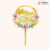 Gold birthday cake topper with pink flowers and 'Happy Birthday' text on a white background, featuring the brand 'Bakeyy'.