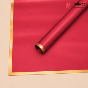 A roll of red bakery paper or wrapping paper with a metallic gold border, shown diagonally on a beige background. The Bakeyy brand logo is visible in the top right corner.