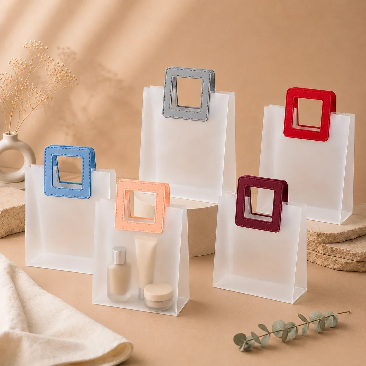 Clear bags with colorful square handles on a beige background