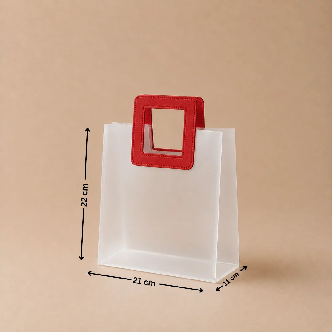 White paper bag with a red handle and measurements on a beige background