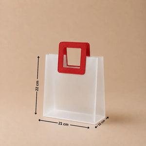 White paper bag with a red handle and measurements on a beige background