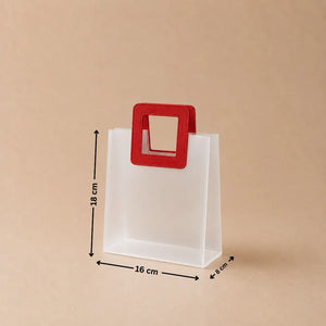 White paper bag with a red handle and measurements on a beige background
