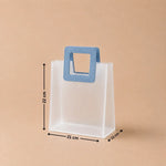 White paper bag with a blue handle and measurements on a beige background