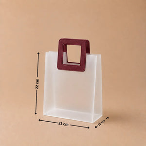 White paper bag with a maroon handle and measurements on a beige background
