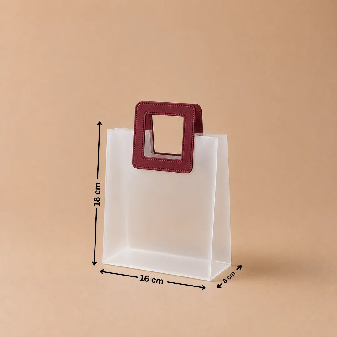 Clear plastic bag with a red handle and measurements on a beige background