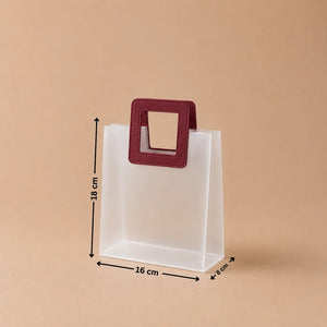 Clear plastic bag with a red handle and measurements on a beige background