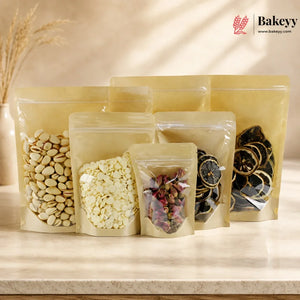 Set of clear stand-up pouches with different contents on a light surface, featuring the brand 'Bakeyy'.