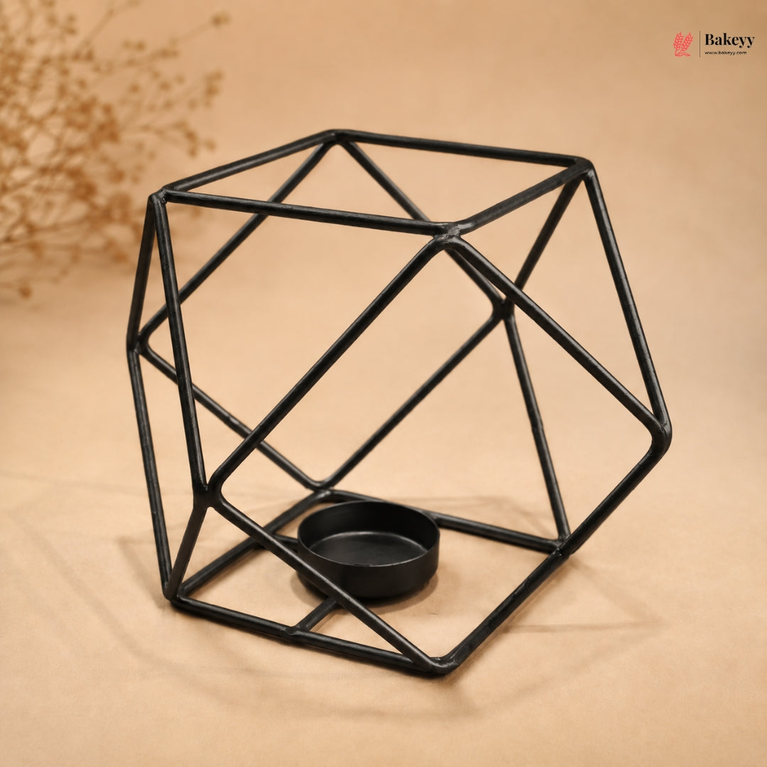 Geometric black metal candle holder on a beige background
