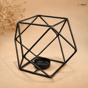 Geometric black metal candle holder on a beige background