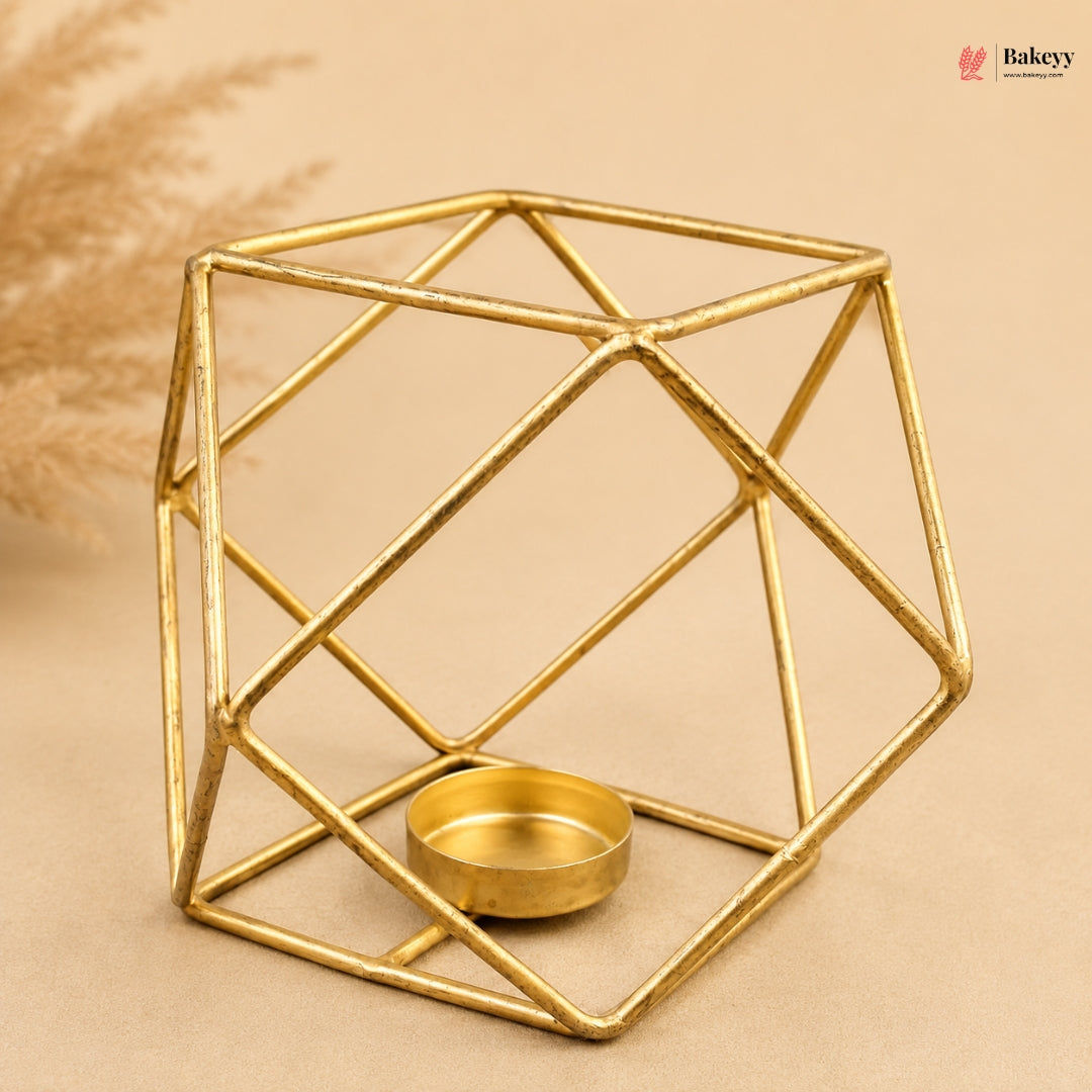 Gold geometric candle holder on a beige background