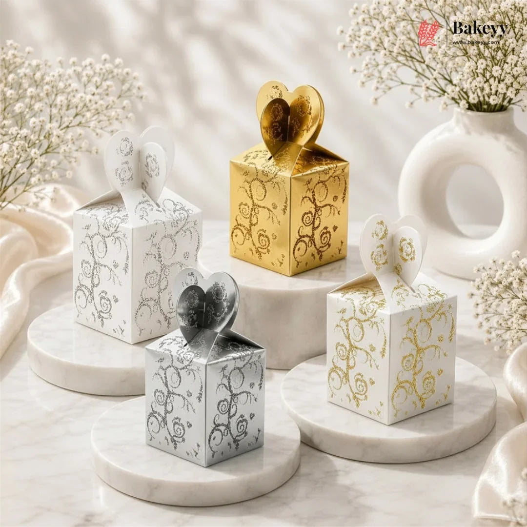 Decorative gift boxes with floral patterns on a marble surface with 'Bakeyv' branding.