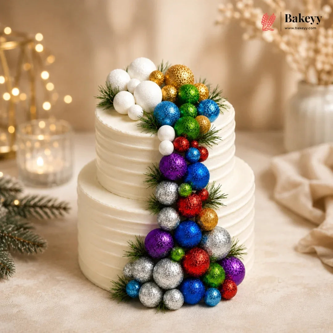 Two-tiered cake decorated with colorful ornaments and Baekyy branding.