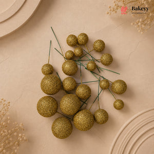 Decorative gold spherical berries on a beige background with 'Bakeyy' branding.