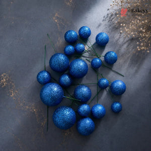Blue glittery berries on a dark textured surface with 'Bakeys' branding.