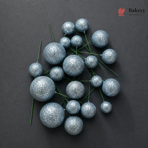 Decorative blue glittery spheres on a dark background with 'Bakeyy' branding.
