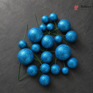 Blue glittery spherical decorations on a dark background with 'Bakeyy' branding.