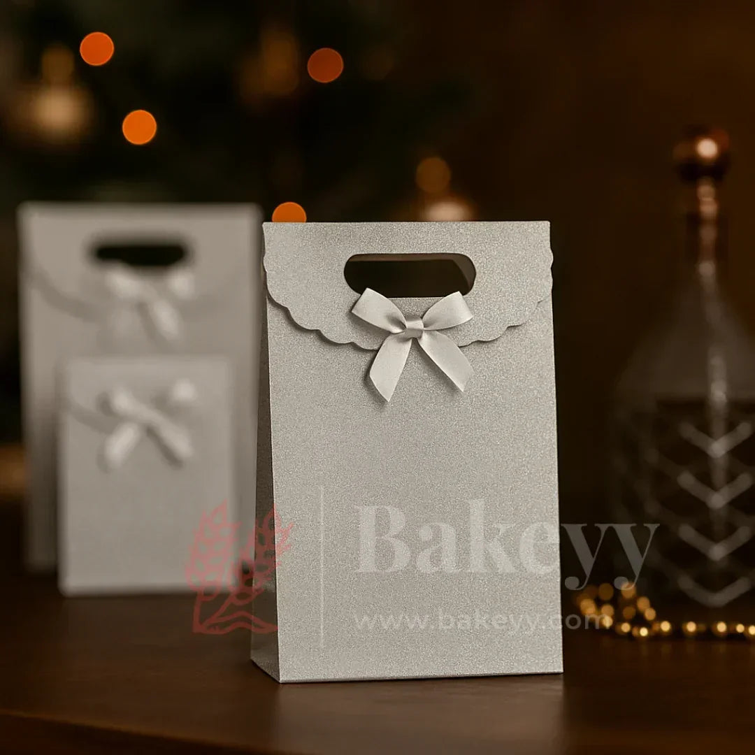Gray paper gift bag with a bow and 'Bakeyy' branding on a dark background.