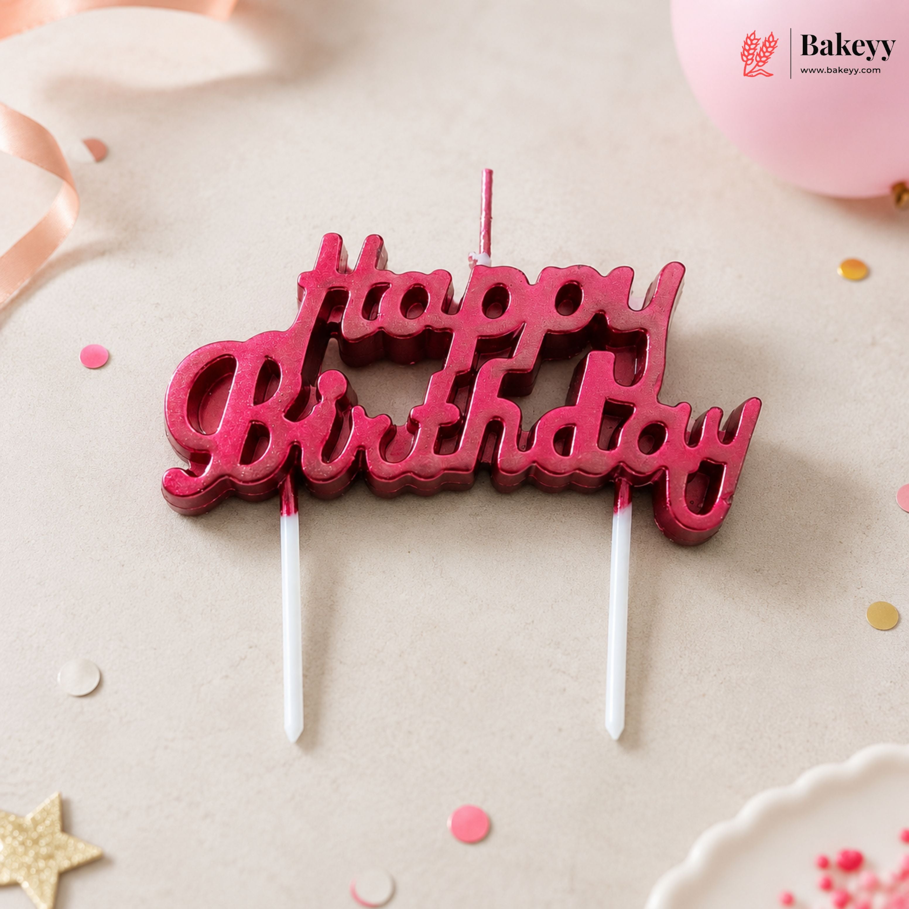 Red 'Happy Birthday' candle topper on a light background with decorative elements.