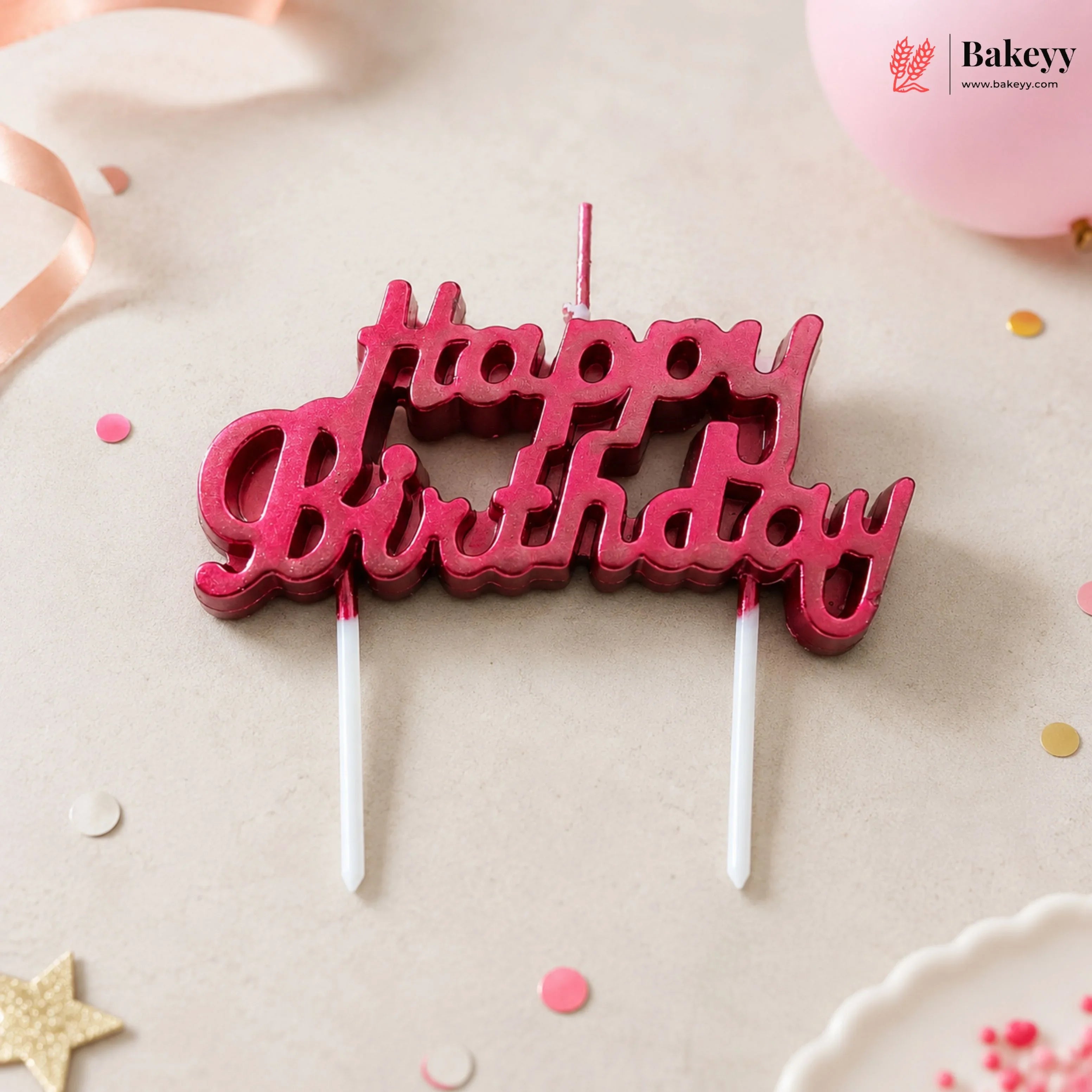 Red 'Happy Birthday' candle topper on a light background with decorative elements.
