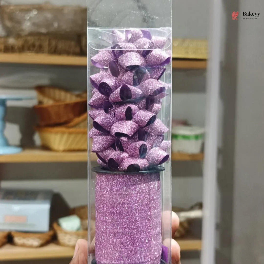 Purple glittery product in a clear tube held by a hand with a blurred background