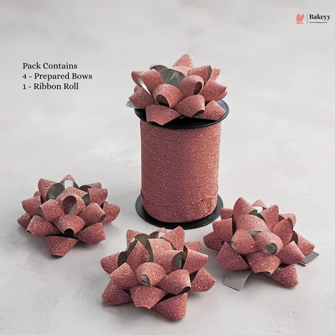 Pink glittery decorative bows with a ribbon roll on a light gray background, featuring the Bakey brand.