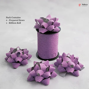 Purple glittery bows with a ribbon roll on a light gray background, featuring Bakeyy branding.