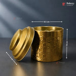 Gold textured container with lid on a dark background, featuring Bakeyy branding.