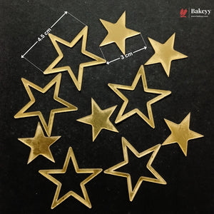 Nine gold-colored star-shaped metal beads or charms arranged on a black background, with white dimension lines and text indicating 4.5 cm by 3 cm measurements.