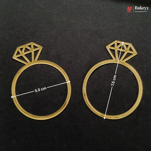 Two gold-colored ring-shaped baking molds with diamond designs on top, displayed on a black background with white dimension lines indicating 5.5 cm and 7.