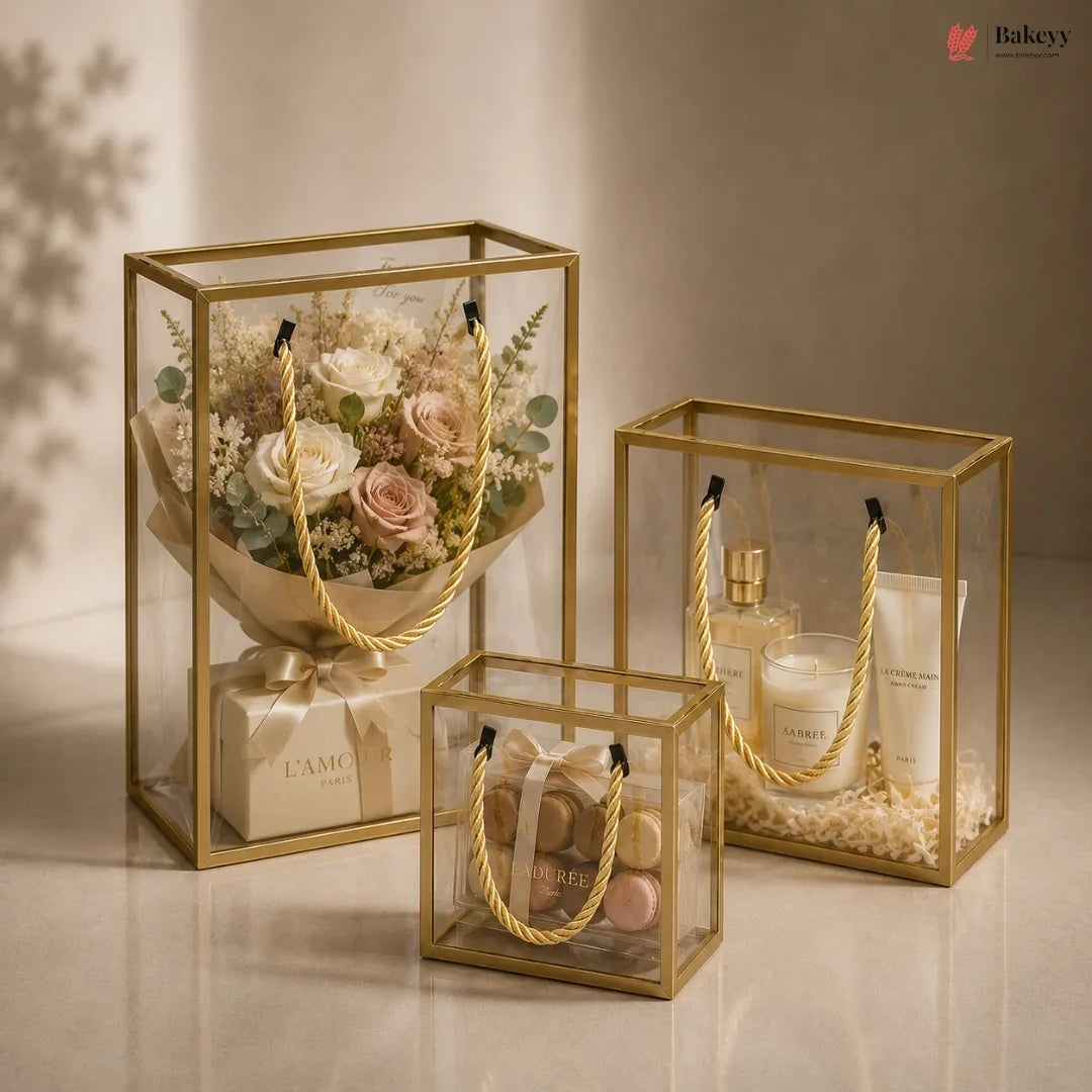Set of three gold glass boxes containing various items on a neutral background